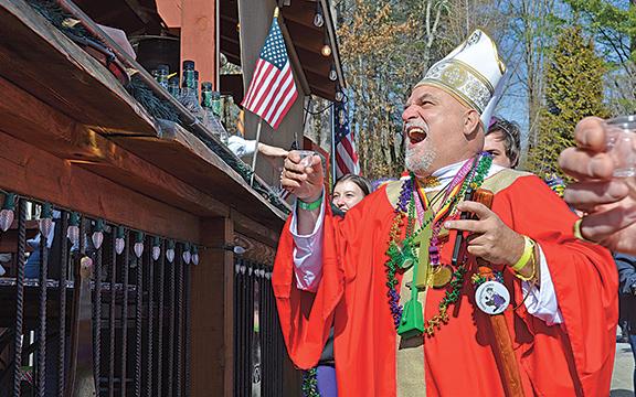 The photo of Gene Walter accepting a schnapp at Two Tire Tavern during the 2023 Fasching parade in Helen won second place in the News Photo category. (Photo/Samantha Sinclair)