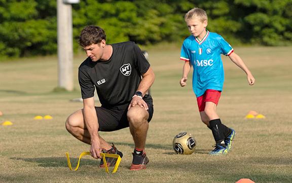 Evan Windham, left, sits up a drill for Wyatt Rickman during the event last week at the Tesnatee Sports Complex. (Photo/Submitted)