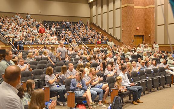 At  White County School System’s opening day gathering for staff, the crowd claps as new employees are asked to stand to be recognized. (Photo/Samantha Sinclair)
