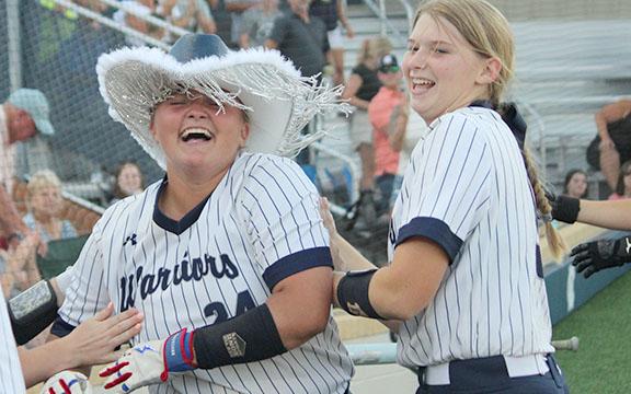 White County's Logan Fain, left, celebrates with Cierra Bailey moments after hitting a two-run home run in the bottom of the seventh inning to give the Lady Warriors an 8-6 win over North Hall in a Region 6-AAA game Monday at the WCHS softball complex. (Photo/Mark Turner)