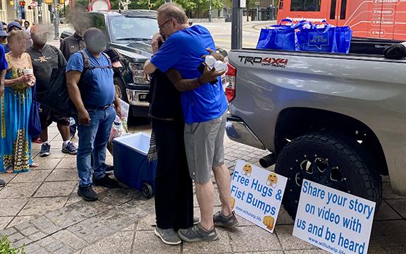 Jeff Edrington offers free hugs to a line of homeless people in Atlanta. (Photo/submitted)