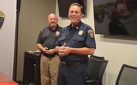 As Public Safety Director David Murphy smiles along in the background, Fire Chief Michael LeFevre shares his joy of having served White County. (Photo/Samantha Sinclair)