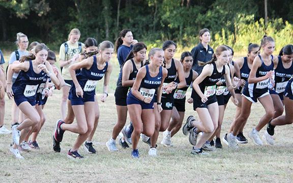 White County runners, from left, Carly Black, Maddie Evans and Emma Windham take off at the start of the girl's varsity race last week at the North Hall Invitational. (Photo/Mark Turner)