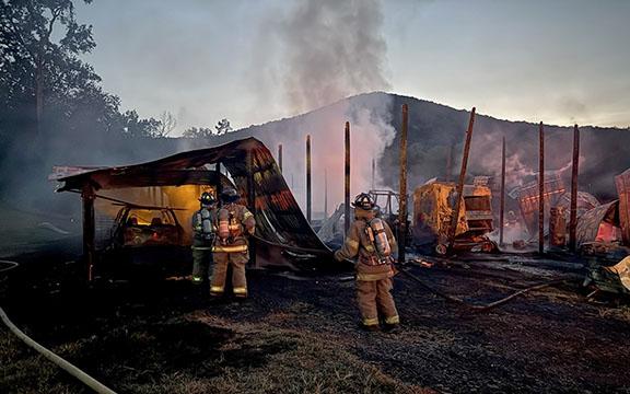Firefighters work to contain a barn fire Monday night. (Photo/Bryce Barrett)