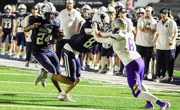 WCHS running back Noel Lammers follows a block from Cooper Adam for a big gain on a pass play during the Warriors' region matchup with Lum[kin County. (Photo/Staci Sulhoff)