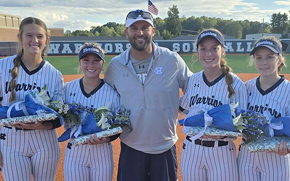 White County knocked off Forsyth Central 5-4 Tuesday night to cap off Senior Night festivities. Shown above are seniors, from left, Hailey Ramey, Emma Hare, WCHS head coach Drew Owens, Aubrey Bolton and Lauren Black. (Photo/Mark Turner)