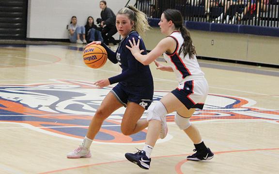 Emma Lightsey, who scored a game-high 21 points, drives past  a Habersham defender during the season opener. (Photo/Mark Turner)
