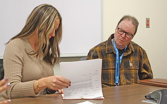 Elections Board Secretary Russell Mobley and Board Member Lorie Crumley review a ballot during the certification process. (Photo/Eric Tiongson)