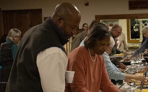 Andy and Stacy Allen, Inda Allen’s brother and mother, go through the potluck buffet. (Photo/Hannah Caudell)