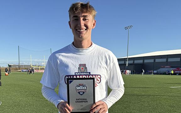 Iyan Windham shows off the NAIA plaque after national championship game Monday in Kansas.  (Photo/Submitted)