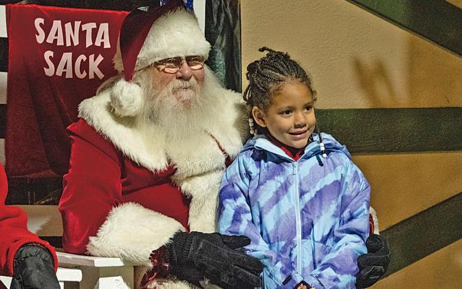 Elaine Mitchell poses for a photo with Santa during Helen’s annual tree lighting event. (Photo/Hannah Caudell)