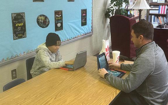 Mentor Brandon Ward (right) spends his lunch hour playing Battleship with his mentee KJ Jackson at Jack P. Nix Elementary School. Ward and Jackson spend time together for 30 minutes each week. (Patrick Fargason/photo)