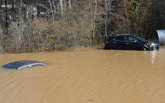Three inches of rain Feb. 13 caused a sinkhole in the staff parking lot of Dalton Family Eyecare on US Hwy. 129 on Feb. 14 that totally submerged a car in water. (Photo/Submitted)