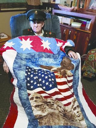 James Sutton wore his original uniform for the ceremony, in which the quilt was draped around him. (Photo/Submitted)