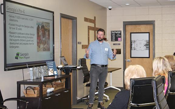Clayton Adams, a community coordinator with the Georgia Department of Early Care and Learning, speaks to local educators and community advocates about the necessity of quality child care during a March 21 Family Connections meeting at the White County School System administrative office. (Photo/Denise Etheridge)