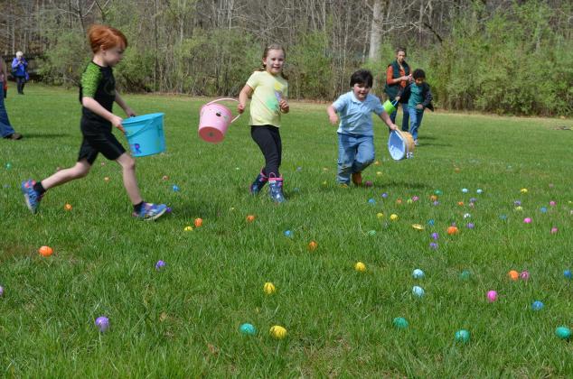 Children race to collect plastic eggs during the Friends of Unicoi State Park’s egg hunt last year. This year’s event will be held on Saturday. (File photo)