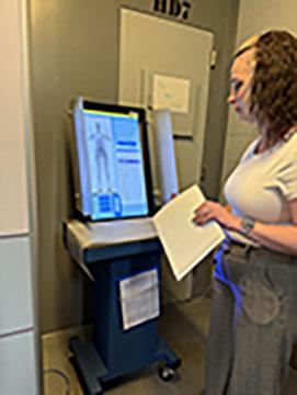 Accreditation Manager Amber Donaldson demonstrates the scans that jailers examine to be sure an inmate hasn’t brought something into the jail. (Photo/Linda Erbele)