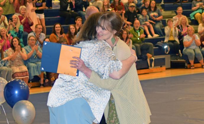 Leann Fuller gets a hug from Laura Corley after being named Teacher of the Year (Photo/Jerry Grillo)
