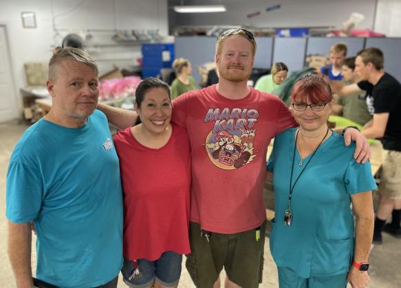 His Hands and Feet Ministry Thrift Store’s monthly food drive is managed by, left to right, Rob Efferson, Shauna Efferson, Scotty Splittorff, and Lisa Ferrari. (Jerry Grillo photo))