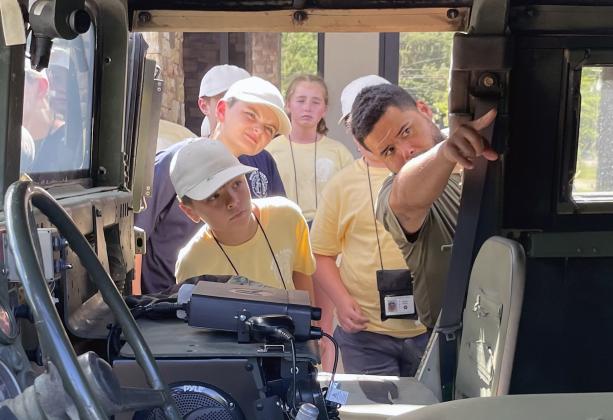 A special operations officer with the White County Sheriff's Office gives local kids an inside look at an armored SWAT vehicle. (Staff photo/Jerry Grillo)