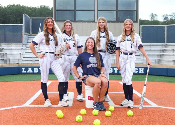 New head coach Cari Barrett, seated, and seniors, from left, Tyla Nix, Logan Fain, Cierra Bailey and Maddie Kate Hall  host Forsyth Central Aug. 5 in the season opener.  MARK TURNER /WCN