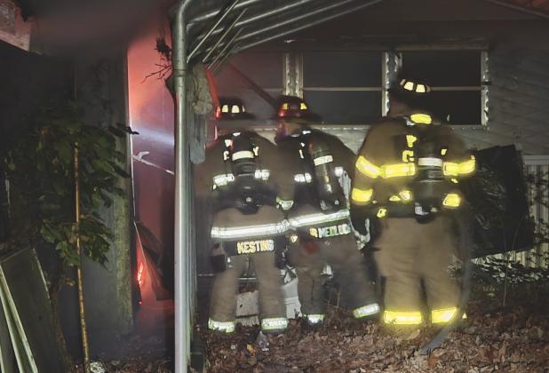 Firefighters Eli Kesting, Bo Medlock, and Randy Galvan battle a house fire. SUBMITTED
