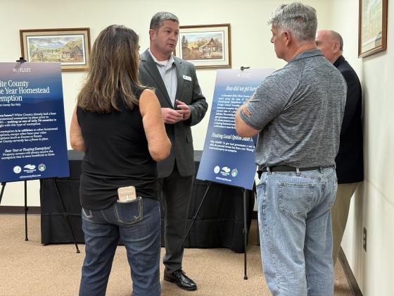 Jamie and Pete Stavros, left and second from right, listen to Derick Canupp, county manager, as he explains how FLOST came to be. Cleveland Director of Economic Development and Planning Tom O’Bryant is far right.  LINDA ERBELE/WCN