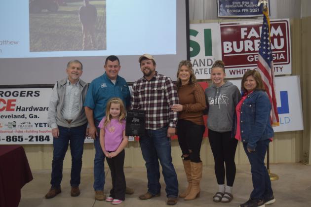 Young Farmer Spotlight Award recipient Adam Kennedy, center, is flanked by dad Gary Kennedy, far left, Matt London, younger daughter Carson, wife Brooke, third from right, older daughter Sawyer, and mom Kathy Kennedy far right.