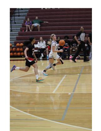 Jossleyn Burke heads to the basket during the Lady Warriors' win over North Gwinnett last Saturday at the 400 Showdown at Dawson County High School. MARK TURNER/WCN