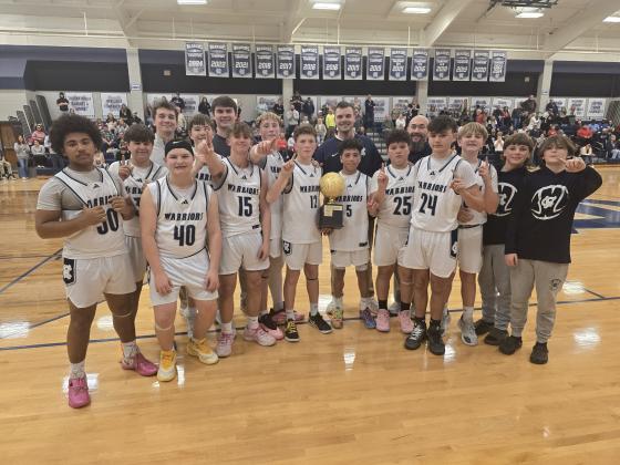 The White County Middle School Warriors show off the NGML trophy after beating Dawson County in the championship game last week at the WCMS gym. The Warriors finished the year with a 14-3 record. MARK TURNER/WCN.