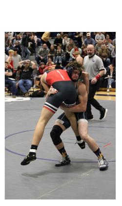 Josh Lane picks up a Stephens County wrestler during the Warriors' win over the Indians on Senior Night. MARK TURNER/WCN.
