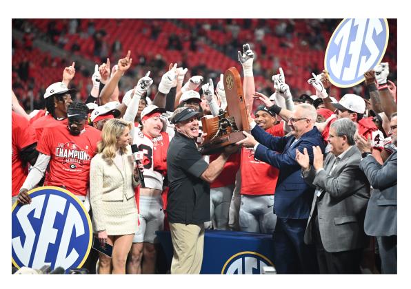 UGA head coach Kirby Smart picks up some hardware after the Georgia Bulldogs rolled past Alabama last weekend in the SEC Championship game in Atlanta. KEITH BARLOW/CNI