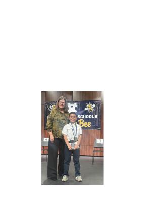 Superintendent Laurie Burckett stands with first place spelling bee winner Reggie Grant. Grant will represent White County in the Georgia Regional Spelling Bee on Feb. 28. SUBMITTED PHOTO
