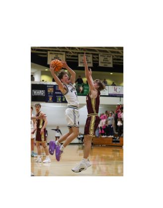 John Jarrard puts up a shot over a Dawson County defender during the region game last Friday in Cleveland.  JENNIFER KNIGHT/SPECIAL