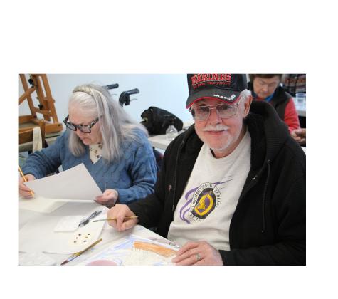 Rebecca LeCouter and Ed LeCouter, USMC Vietnam Veteran, work on painting watercolor windmills in last Thursday’s class. CARLY HENDERSON/WCN