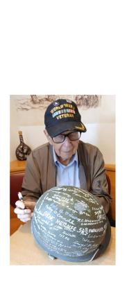 Alan Kinder, 101, signs a World War II-era helmet during the Lunch with Veterans gathering. Kinder served in the U.S. Army from 1943 to 1945. SUBMITTED PHOTO