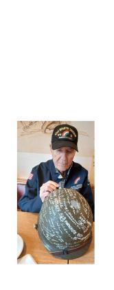 Hilbert “Hibby” Margol, 102, signs a World War II-era helmet. Margol served in the U.S. Army from 1943 to 1946 and was part of the 42nd “Rainbow” Infantry Division that liberated Dachau concentration camp. SUBMITTED PHOTO