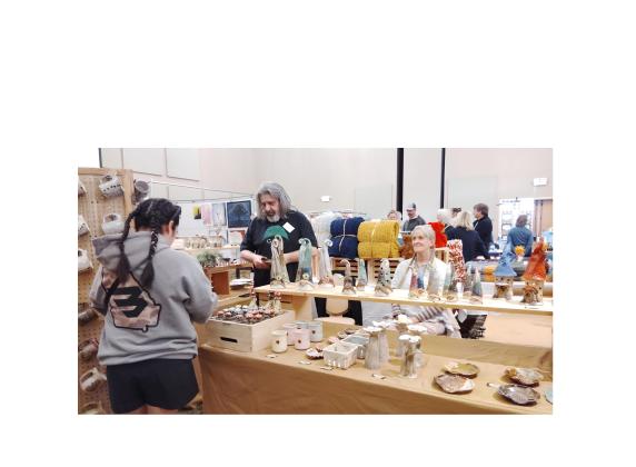Potters Tony Betzhold, left, and his partner Christie Walker of Murphy, N.C., exhibited at WinterFest  last weekend. The pair own and operate Woodland Farms Pottery. DENISE ETHERIDGE/WCN