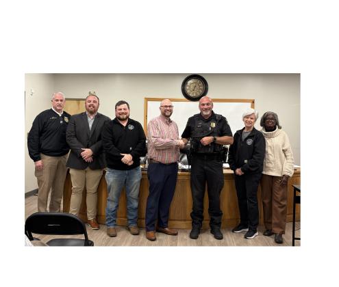 From left, Cleveland Police Chief Jeff Shoemaker, Council members CJ McDonald and Jeremy McClure, Mayor Josh Turner, Officer David Bruce, and Council members Nan Bowen and Annie Sutton gather as Bruce is recognized as the 2025 Officer of the Year at the March 2 meeting of the Cleveland City Council. CARLY HENDERSON/WCN