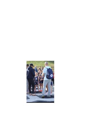 Coach John Rosenbaum, left, and Coach Shane Caudell, right, talk to Stella Caudell, Bella Ellis and Bella Frawley before an event during the meet. WCRD ATHLETICS/SPECIAL