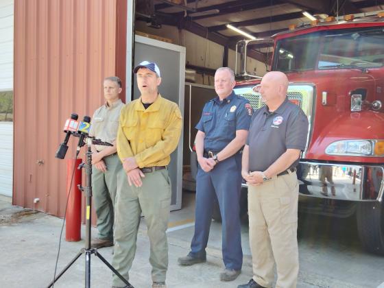 U.S. Forest Service Incident Commander Dan Cottrell speaks during a briefing on the Buzzard Mountain fire Monday afternoon. White County Public Safety Director David Murphy, far right, looks on. DENISE ETHERIDGE/WCN