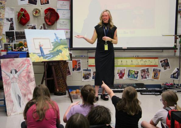 Future Mossy Creek Elementary School art teacher Mary Grace Nelson displays her artwork and talks with students during Career Day.