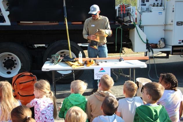 Chris Smith of Georgia Power demonstrates equipment used in the field for students during Career Day.