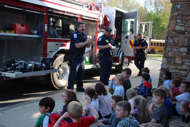 Firefighters Eli Kesting and Will LaPree and Captain Bo Medlock with the White County Fire Department discuss their work with students at Career Day.