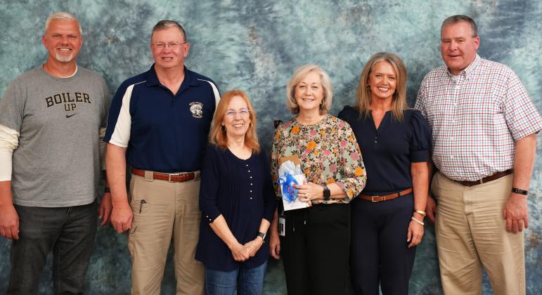 Lin Pahl, center, was honored for her service as an executive assistant to the superintendent. Pahl retired on Tuesday. From left: School Board Members Jon Estes, Charlie Thomas and Linda Erbele, Pahl, School Board Chair Missy Jarrard and School Board Member John Solmon.