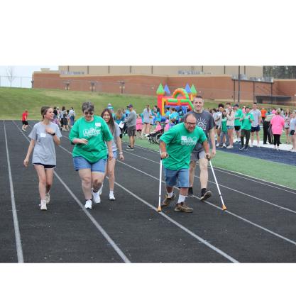 Brittany Freeman, left, and Mitchell Hawkins head toward the finish line of a 50-meter event.
