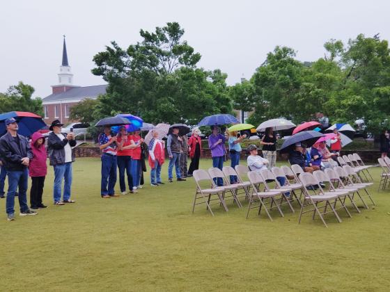 About 25 people braved the rain to attend a Memorial Day observance in Cleveland on May 25. DENISE ETHERIDGE/WCN