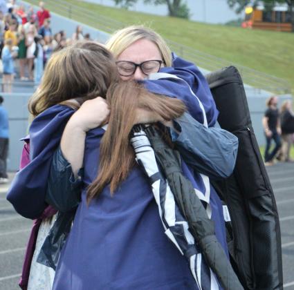A graduate and a parent share an emotional hug following the 2026 White County High School graduation ceremony. CARLY HENDERSON/WCN