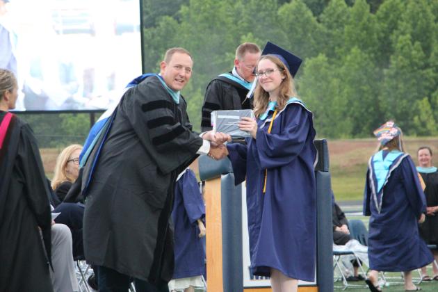 School Superintendent Jonathan Stribling presents valedictorian Allyssa Harkins with her diploma during the 2026 White County High School graduation ceremony. CARLY HENDERSON/WCN
