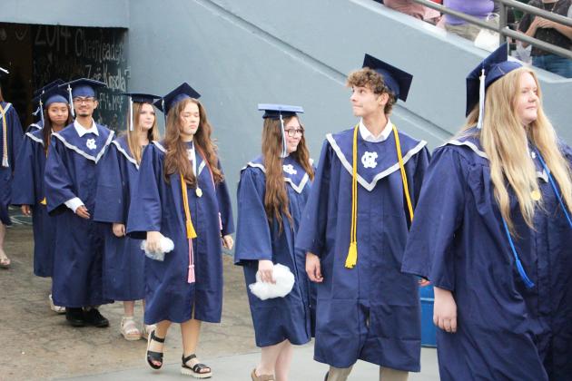 Graduates look around as they emerge from the tunnel into Warrior Stadium for the 2026 White County High School graduation ceremony. CARLY HENDERSON/WCN